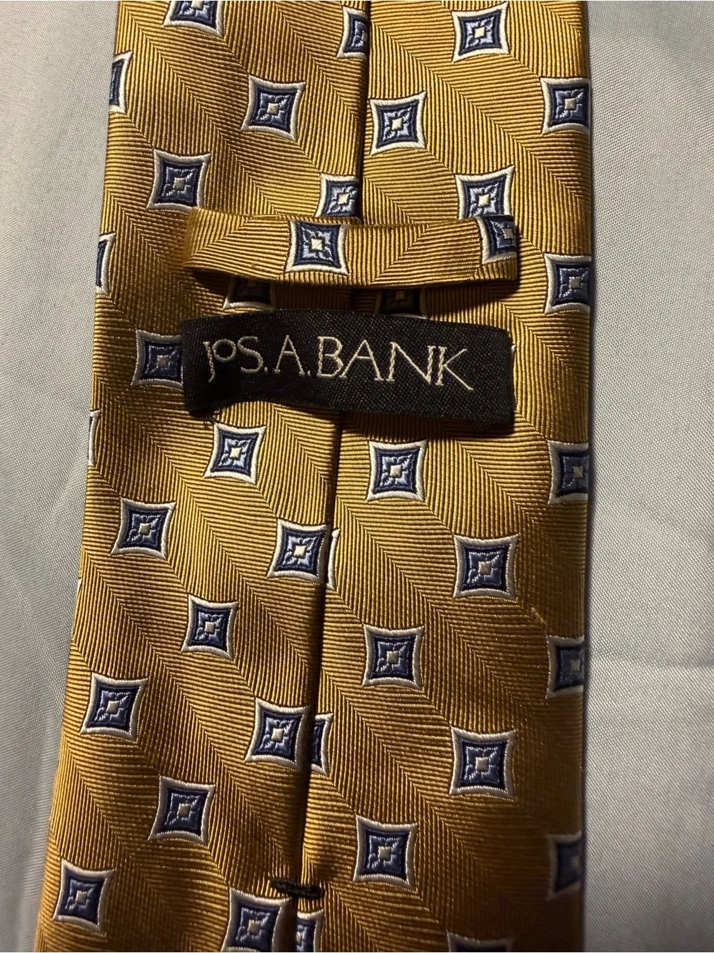 Jos. A. Bank Gold Tie with Navy Geometric Medallions